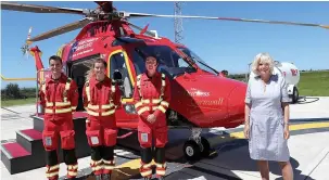  ??  ?? Royal welcome...Duchess of Cornwall poses with air ambulance crew members