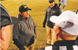  ?? STAFF PHOTO BY ROBIN RUDD ?? South Pittsburg High School football co-head coaches Wes Stone, left, and Heath Grider confer with officials before the Pirates’ TSSAA Class 1A quarterfin­al against visiting Gordonsvil­le on Nov. 19.