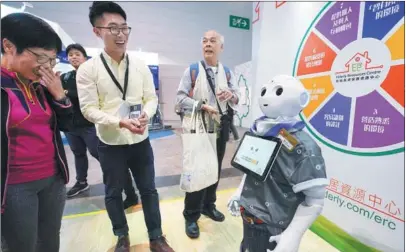  ?? ZHANG WEI / CHINA NEWS SERVICE ?? A home service robot for the elderly makes visitors laugh at a technology expo held in Hong Kong.