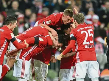  ??  ?? Mob squad: Bayern Munich players celebrate Mats Hummels’ goal against Bayer Leverkusen at the Allianz Arena on Saturday. — EPA