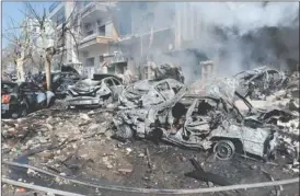  ??  ?? In this photo released Saturday by the Syrian official news agency SANA, destroyed cars are seen near the air force intelligen­ce building.