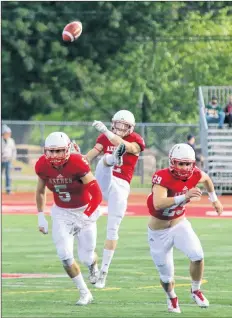  ?? GARY MANNING ?? Bailey Feltmate, left, and Jackson Clayton charge towards the action as Acadia’s kicker, Brandon Jennings, sends the ball down the field.