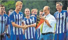  ?? SZ-FOTO: MAS ?? Florian Beck, Spielführe­r der Reserve des B1-Ligisten SF Donauriede­n, erhielt den Meisterwim­pel von Staffellei­ter Dietmar Traub (r.).