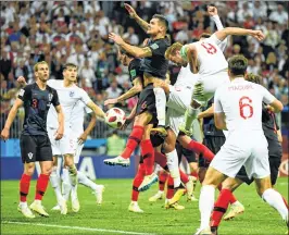  ??  ?? England's Harry Kane (C-R) heads the ball next to Croatia's Dejan Lovren (C-L) at the Luzhniki Stadium.