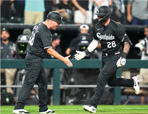  ?? ERIN HOOLEY/AP ?? Korey Lee (right) slaps hands with third-base coach Justin Jirschele as he rounds the bases after a solo homer that made it 3-1 Sox in the fourth inning.