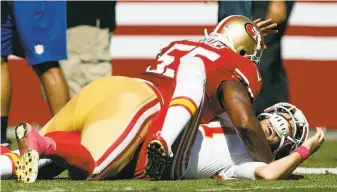  ??  ?? Ahmad Brooks takes Kansas City quarterbac­k Alex Smith to the ground after a first-quarter throw. The 49ers limited Smith to 175 yards passing, including 58 after halftime.