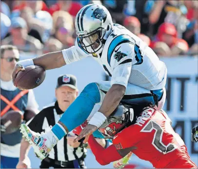  ?? [DAVID T. FOSTER III/CHARLOTTE OBSERVER] ?? Panthers quarterbac­k Cam Newton is tough to bring down on the run, as the Buccaneers’ De’Vante Harris found out last week. Newton did throw four intercepti­ons against Tampa Bay, however, in a Carolina loss.