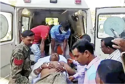  ?? Associated Press ?? A policeman injured in an ambush is taken on a stretcher out of an ambulance in Dantewada district on Tuesday. Raipur:amaoistamb­ushontuesd­ay