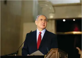  ?? (Reuters) ?? PRIME MINISTER Benjamin Netanyahu speaks after reading from the Book of Esther at a synagogue in Jerusalem.