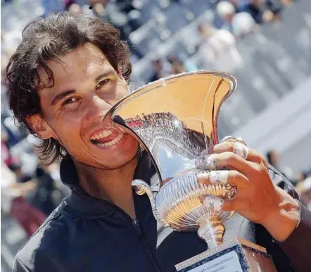  ??  ?? Champ again: Rafael Nadal posing with the trophy after winning his final match against Novak Djokovic at the Rome Masters in Rome yesterday. — Reuters