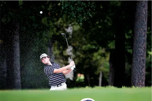  ?? Staff photos by Evan Lewis ?? Pleasant Grove’s Braxton Watkins chips onto the green on the first hole Saturday during the final round of the Tiger Fall Classic at Texarkana Country Club.