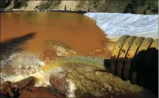  ?? AP PHOTO/BRENNAN LINSLEY ?? In this Aug. 14, 2015 file photo, water flows through a series of retention ponds built to contain and filter out heavy metals and chemicals from the Gold King mine chemical accident, in the spillway about 1/4 mile downstream from the mine, outside...