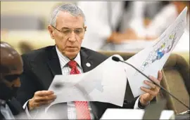  ?? Robert Willett Raleigh News & Observer ?? NORTH CAROLINA state Rep. John Szoka reads a redistrict­ing map in 2019. In the state, the GOP-dominated legislatur­e has complete control of redistrict­ing.