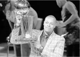  ?? MICHAEL DWYER/ASSOCIATED PRESS ?? Former Boston Celtics star Paul Pierce holds the NBA championsh­ip trophy that he won with the team in 2008 during a ceremony Sunday to retire his jersey No. 34.