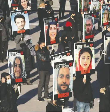  ?? Chris Young / THE CANADIAN PRESS ?? Placards in Toronto on Friday reflect heavy hearts a calendar year after the Iran Air crash. More than 100 of the 176 victims had ties to Canada.