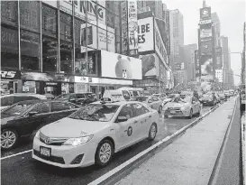  ?? [AP FILE PHOTO] ?? Traffic makes its way down Seventh Avenue in New York’s Times Square. Cruise Automation, a self-driving software company owned by General Motors, will start testing in New York in early 2018. They’ll have an engineer behind the wheel to monitor...