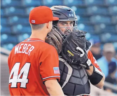  ?? JIM THOMPSON/JOURNAL ?? Isotopes catcher Tom Murphy talks with pitcher Thad Weber during Wednesday night’s game. Murphy is learning how to manage a pitching staff, a skill that will benefit him in the majors.