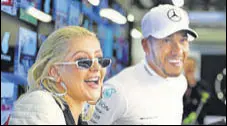  ?? GETTY IMAGES ?? Popstar Christina Aguilera with Lewis Hamilton after the Formula One driver won the Azerbaijan Grand Prix on Sunday.