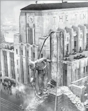  ??  ?? A WORKER uses a jackhammer to help demolish the former Times building in 1937. Behind him stands the paper’s current facility, at 1st and Spring streets in downtown Los Angeles.