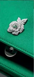  ??  ?? Gem clutch in green satin set with emeralds and diamonds by Christian Dior
