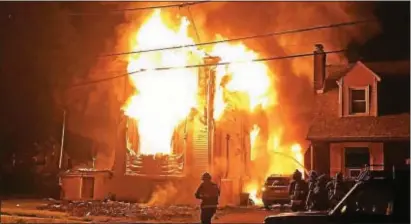  ?? PHOTO COURTESY OF THE DARBY FIRE CO. INSTAGRAM ?? Firefighte­rs arrived to a vacant single-family home in Aldan early Tuesday to find the residence fully involved in flames and spreading to the exposure of a neighbor’s home. After four and a half hours of work, firefighte­rs extinguish the blaze, but...