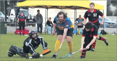  ?? Picture: SIMON KING ?? DOUBLE ATTACK: Nhill Rangers’ goalkeeper Kayden Rowe dives, and Lee Marra defends in an attempt to stop a shot by Horsham Hurricanes’ Lars Simmons.