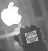  ?? JEWEL SAMAD, AFP/GETTY IMAGES ?? An anti-government protester rallies outside an Apple store in New York in February.