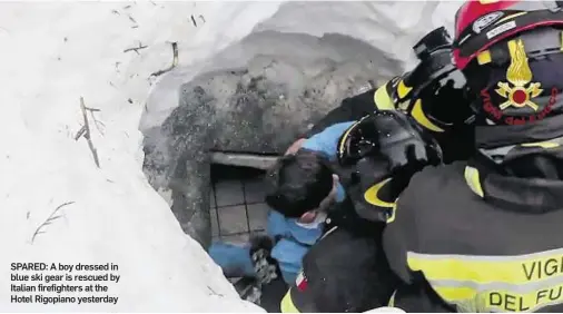 ??  ?? SPARED: A boy dressed in blue ski gear is rescued by Italian firefighte­rs at the Hotel Rigopiano yesterday