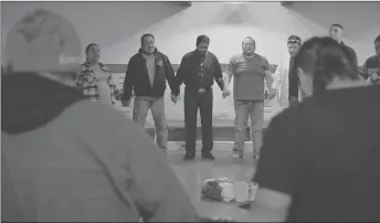  ?? Attached photos (all photos courtesy of the National Film Board of Canada) ?? Image from the film: Clients at the Kainai Healing Lodge standing with Sean Chief Moon and Bryan Smith, addiction counsellor­s.