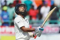  ?? AP ?? India’s Cheteshwar Pujara celebrates after completing his half-century during the second day of the fourth Test.