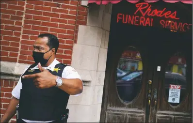  ??  ?? Police Cmdr. Rahman Muhammad stands outside a funeral home where a shootout wounded 15 in the Auburn Gresham neighborho­od.