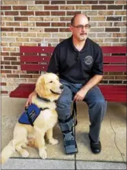  ?? DONNA ROVINS — DIGITAL FIRST MEDIA ?? Birdsboro Borough Manager Aaron Durso took his new seizure response service dog to a meeting at borough hall Aug. 15. Dexter will assist Durso with the frequent seizures he experience­s — providing comfort, alerting family, and retrieving medicine.