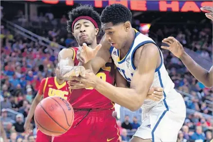  ?? Photograph­s by Wally Skalij Los Angeles Times ?? THE BALL IS LOOSE after USC’s Elijah Stewart and UCLA’s Ike Anigbogu are unable to find the handle during the first half of the Pac-12 quarterfin­al matchup in Las Vegas. Stewart fouled out in the final seconds after scoring 17 points.