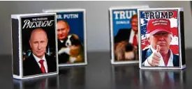  ?? REUTERS ?? SUMMIT SOUVENIRS Matchboxes with pictures of Russian President Vladimir Putin and US President Donald Trump are displayed at a shop window in Helsinki, Finland.—