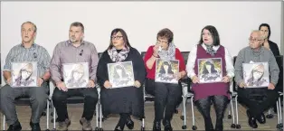  ?? JOE GIBBONS/THE TELEGRAM ?? Family members of Cortney Lake hold photograph­s of her Tuesday at a news conference at RNC headquarte­rs in St. John’s.