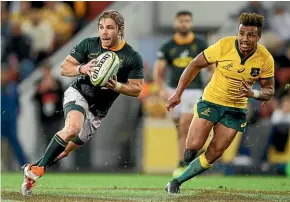  ??  ?? Springboks halfback Faf de Klerk attempts to evade Wallabies opposite Will Genia, in Brisbane.