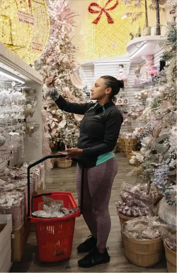  ?? CARL JUSTE cjuste@miamiheral­d.com ?? Ivonne Plata, 37, shops for Christmas decoration­s at the Christmas Palace in Hialeah Gardens. The retailer, nearing its 30th anniversar­y, is seeing a surge of demand but is struggling to keep up due to supply chain issues.