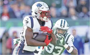  ?? BRAD PENNER/USA TODAY SPORTS ?? Patriots running back Sony Michel runs past Jets safety Jamal Adams. Michel finished the game with 133 rushing yards and a TD.