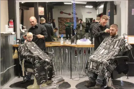  ?? CHARLES PRITCHARD - ONEIDA DAILY DISPATCH ?? Richard Rossi, left, and Nick Hart, right, trim and cut hair at the Oneida Barber Shop on Saturday, Nov. 17, 2018.