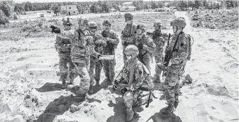  ?? Laetitia Vancon / New York Times ?? Capt. Sean Brown of the U.S. Army National Guard, second from left, goes over an upcoming training exercise outside Vilnius, Lithuania. In the face of expected criticism from the American president, NATO allies are expected to emphasize the gains they...