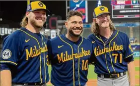  ?? Phil Long / Associated Press ?? Milwaukee Brewers starter Corbin Burnes, left, poses with catcher Omar Narvaez, center, and reliever Josh Hader as they celebrate a no-hitter.