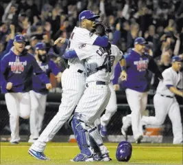  ?? DAVID J. PHILLIP/ THE ASSOCIATED PRESS ?? Cubs catcher Willson Contreras and relief pitcher Aroldis Chapman embrace after advancing to the World Series with a 5-0 victory over the Los Angeles Dodgers in Game 6 of the National League Championsh­ip Series at Wrigley Field in Chicago on Saturday...