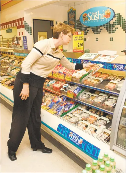  ?? Hearst Connecticu­t Media file photo ?? Patricia Monaco, a customer at Stop &amp; Shop on Lake Avenue in Danbury, looks at the sushi.