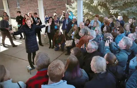  ?? Scott Olson/Getty Images ?? Sen. Elizabeth Warren, D-Mass., greets an overflow crowd outside of the Our Place Community Center before participat­ing in a roundtable discussion on Saturday in Storm Lake, Iowa.