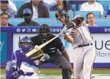  ?? Mark J. Terrill / Associated Press ?? Giants catcher Buster Posey hit a tworun home run to kick off the first game of a major fourgame series at Dodger Stadium.