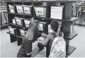  ?? [PHOTO PROVIDED] ?? An excited first-grader picks out school supplies with Back2Schoo­l volunteer Kayla Tinsley.