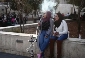  ??  ?? People smoking hookah in Hashemite Plaza, Amman, Jordan. Photograph: Valery Sharifulin/TASS/Getty Images