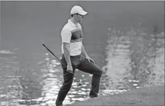  ?? FRANK FRANKLIN II/AP PHOTO ?? Rory McIlroy of Northern Ireland lines up a shot from the rough on the 17th hole during the second round of the Travelers Championsh­ip on Friday at TPC River Highlands in Cromwell.