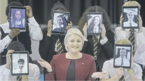  ??  ?? 0 CGI vice-president Justene Ewing with students from St Thomas Aquinas RC Secondary School and their ipads