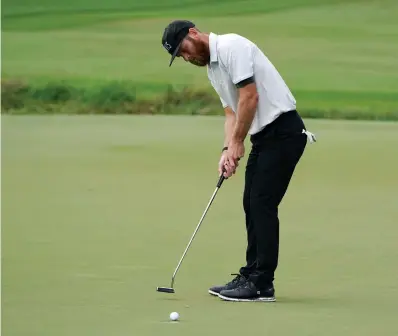  ?? AP Photo/Chris Carlson ?? ■ Tyler Mccumber putts on the seventh hole during the second round of the Wyndham Championsh­ip golf tournament on Aug. 14 at Sedgefield Country Club in Greensboro, N.C.